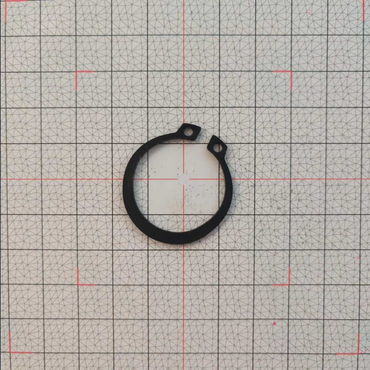 Phone photo of an external circlip on an Olypsys grid